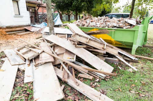 Construction workers managing builders waste on a London site